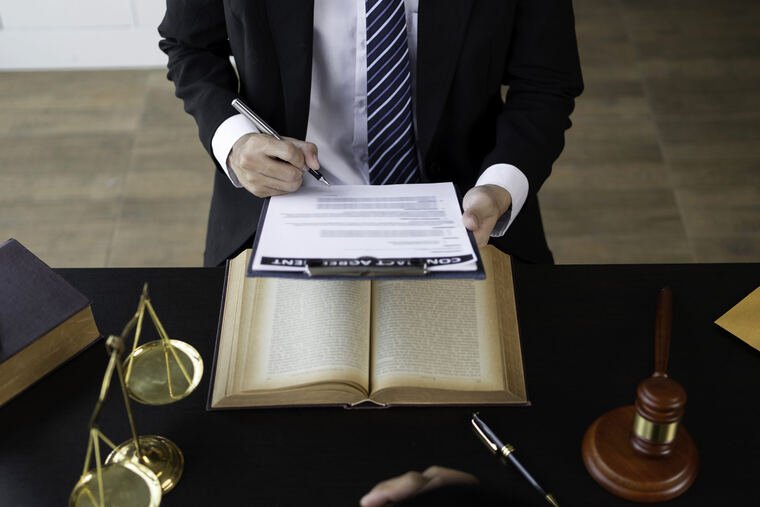 Attorney reviewing claim documents at a desk