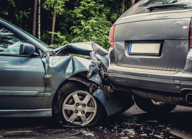 Two cars with heavy front and rear damage after a collision