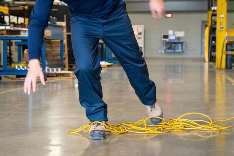 Cable stretched across a walkway, a trip hazard